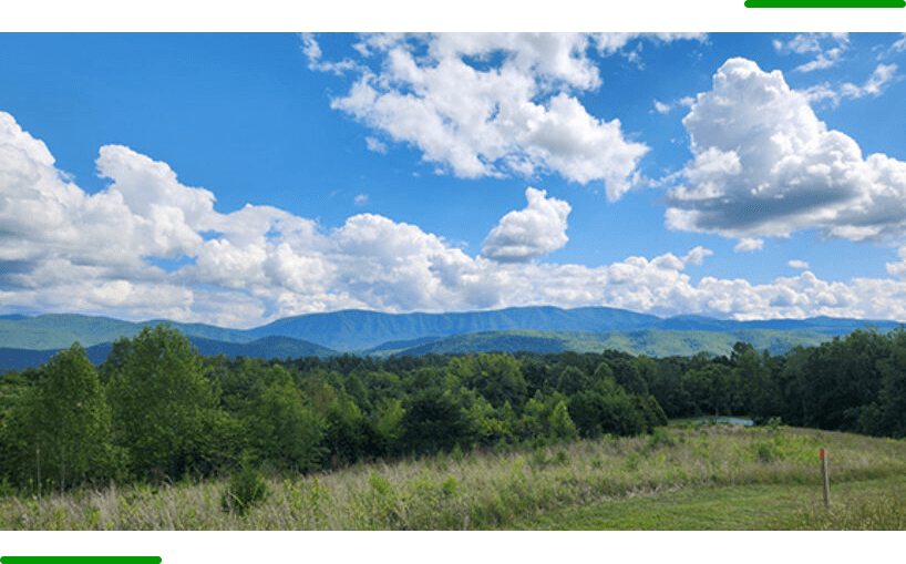 A view of the mountains from across the field.